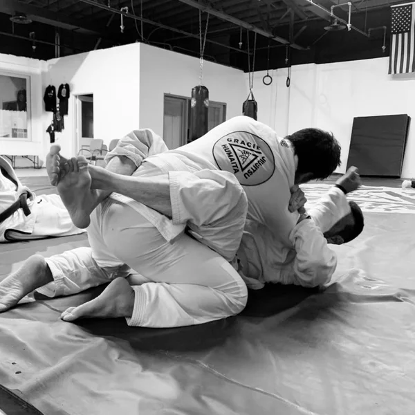 Two practitioners rolling at Gracie Humaita KC.